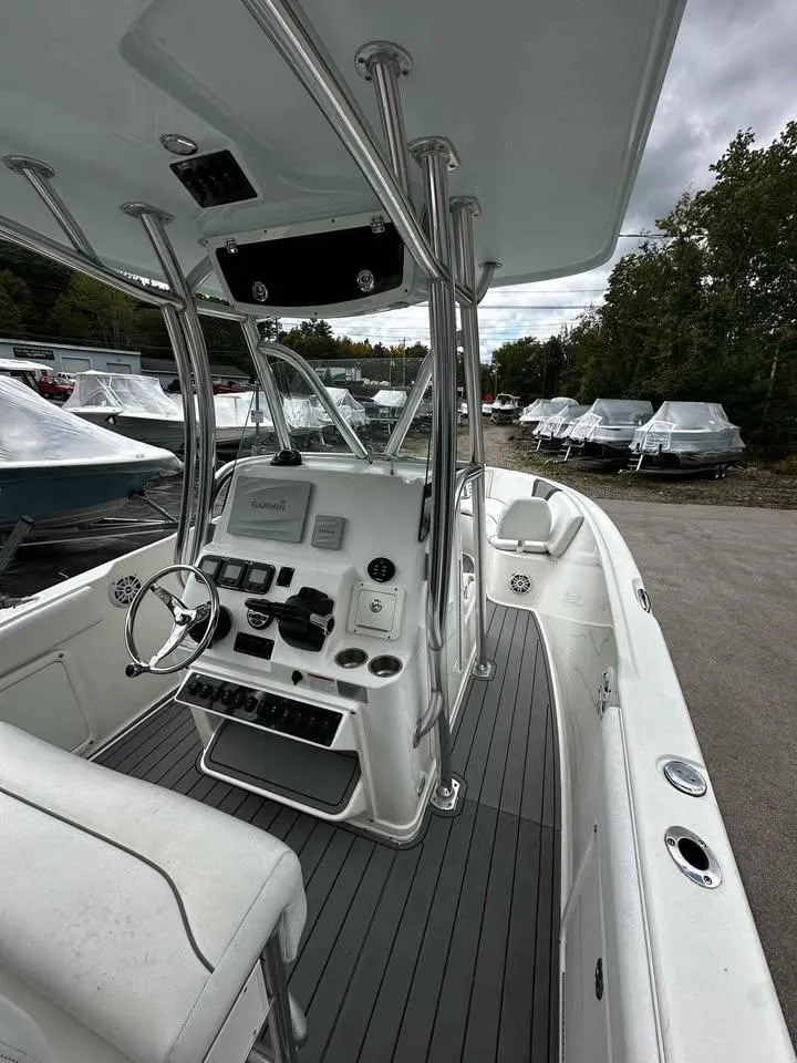 Slide: The Image of 2015 Century 2600 CC boat interior with steering console and seating, docked outdoors. - 6