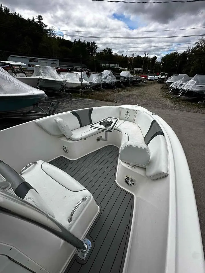 Slide: The Image of 2015 Century 2600 CC boat with sleek seating, docked outdoors under cloudy skies. - 7