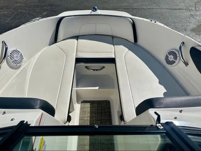 Slide: The Image of 2018 Sea Ray SPX 210 boat interior with white seating and speakers. - 10