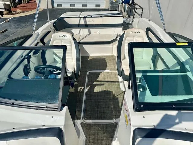 Slide: The Image of 2018 Sea Ray SPX 210 boat interior with seating and steering wheel. - 11