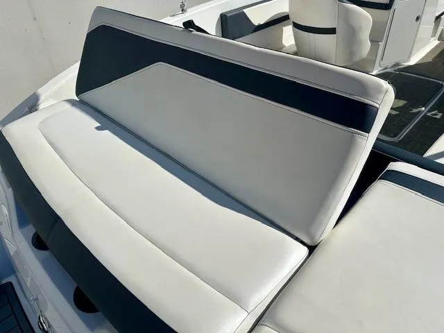Slide: The Image of 2018 Sea Ray SPX 210 boat interior with white and black seating. - 12