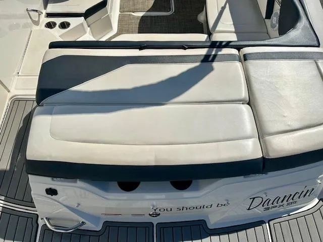 Slide: The Image of 2018 Sea Ray SPX 210 boat with cushioned seating and deck view. - 13