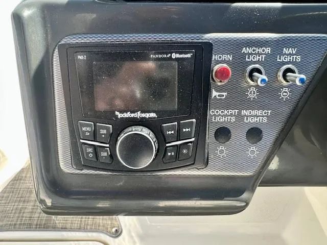 Slide: The Image of Control panel of a 2018 Sea Ray SPX 210 boat with audio system and light switches. - 14