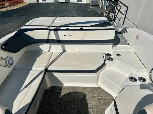 Slide: The Image of 2018 Sea Ray SPX 210 boat interior with white seating and cup holders. - 7