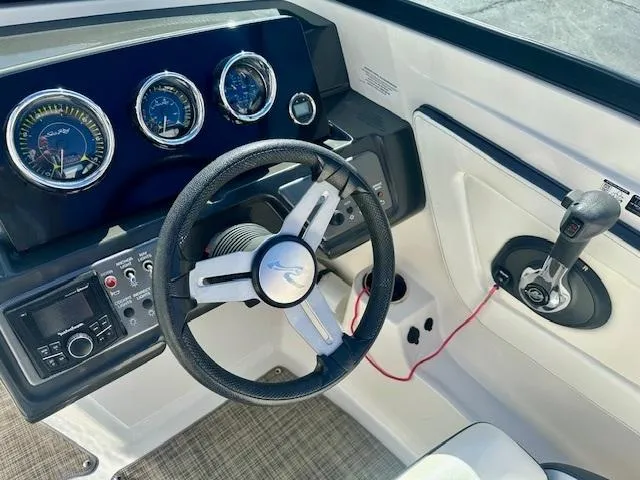 Slide: The Image of 2018 Sea Ray SPX 210 boat dashboard with steering wheel and control panel. - 9