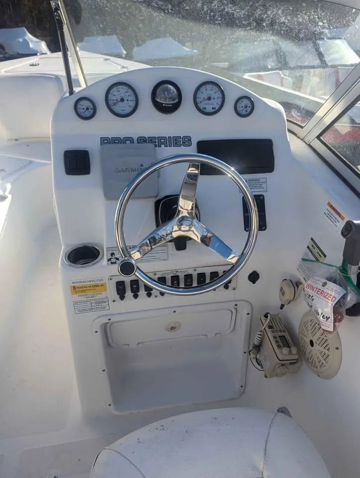 Slide: The Image of 2012 Sea Fox 236CC Pro Series boat dashboard with steering wheel and gauges. - 12