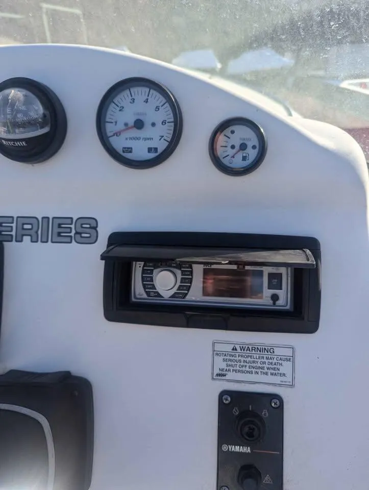 Slide: The Image of Dashboard of a 2012 Sea Fox 236CC Pro Series boat with gauges and controls. - 13