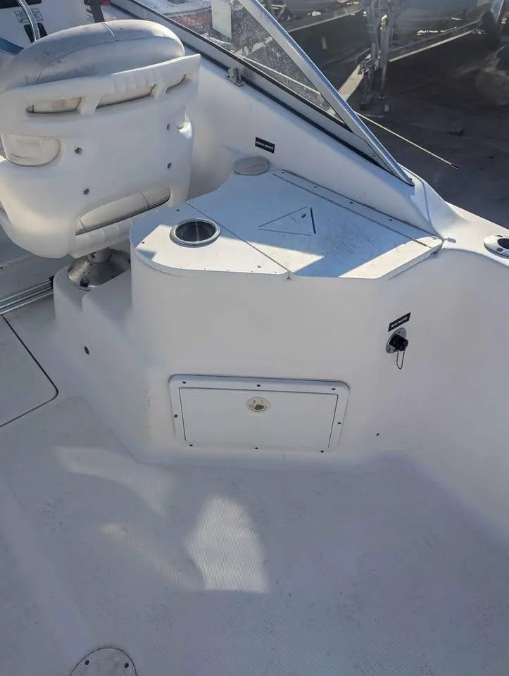 Slide: The Image of 2012 Sea Fox 236CC Pro Series boat interior with seating and storage compartments. - 19