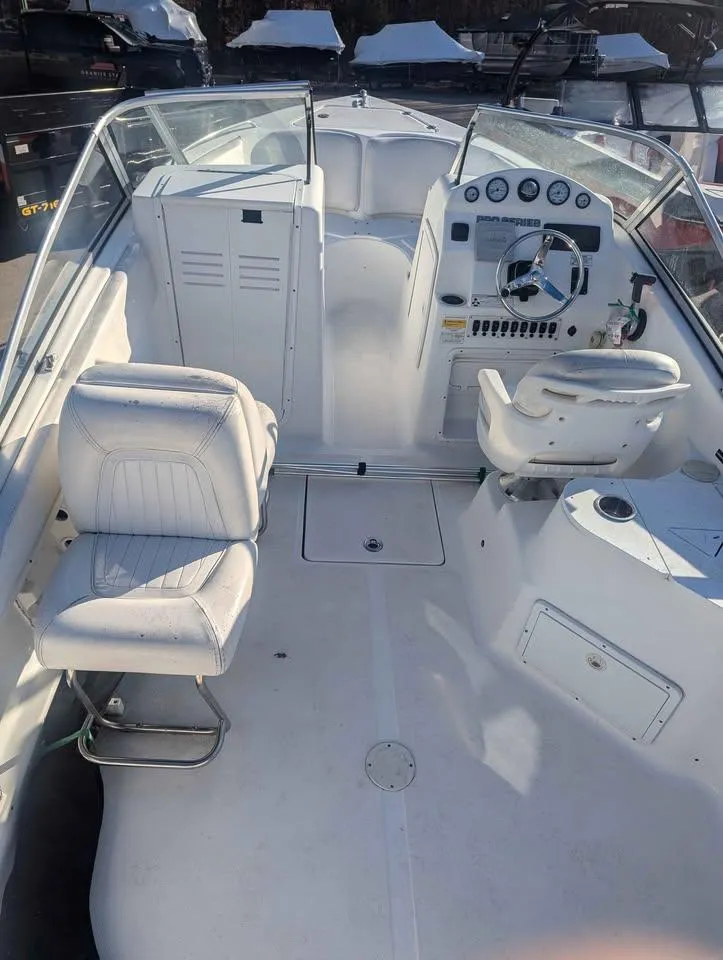 Slide: The Image of 2012 Sea Fox 236CC Pro Series boat interior with white seating and control panel. - 6