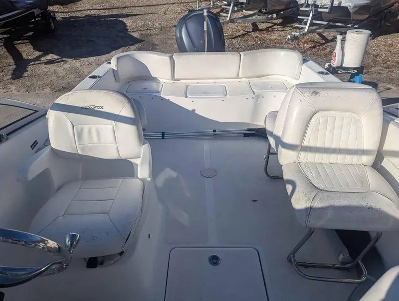Slide: The Image of 2012 Sea Fox 236CC Pro Series boat interior with white seating and steering wheel. - 8