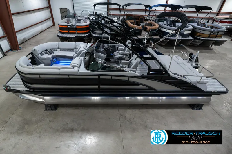 Slide: The Image of 2025 Bennington 23 RSBWA pontoon boat in showroom, sleek design, luxury seating. - 1