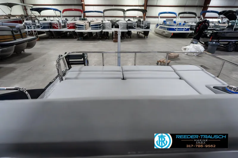 Slide: The Image of 2025 Bennington 23 RSBWA pontoon boat in showroom with multiple boats in background. - 17