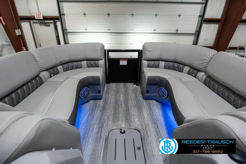 Slide: The Image of 2025 Bennington 23 RSBWA pontoon boat interior with gray seating and blue LED lighting. - 21