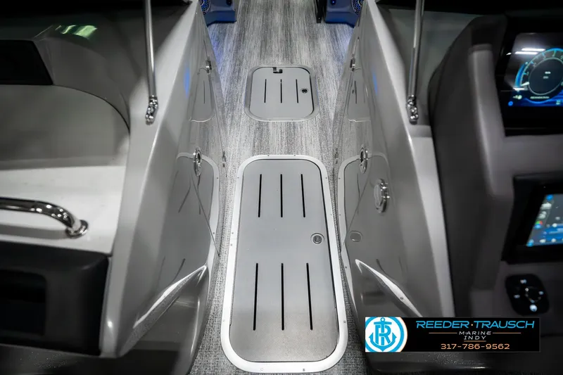 Slide: The Image of 2025 Bennington 23 RSBWA boat interior with sleek flooring and modern dashboard. - 25