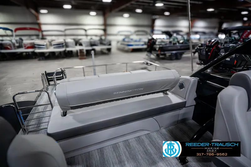 Slide: The Image of 2025 Bennington 23 RSBWA boat interior in showroom with seating and logo. - 28
