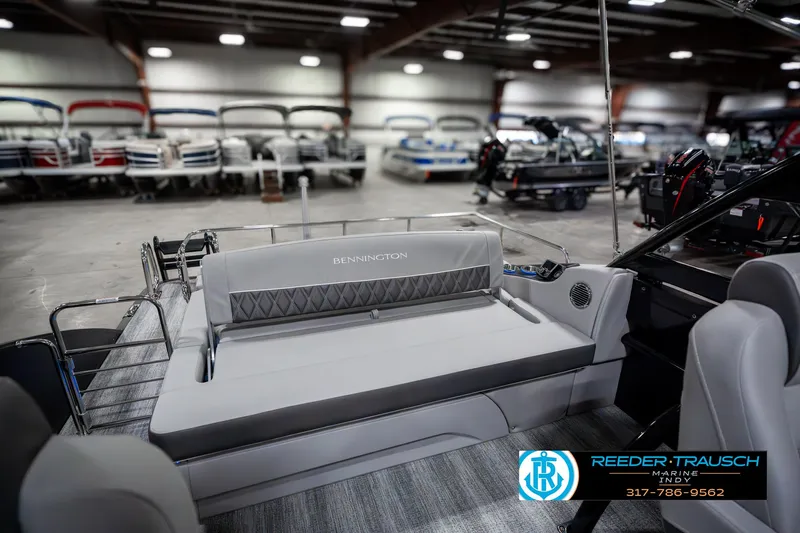Slide: The Image of 2025 Bennington 23 RSBWA boat interior in showroom, featuring sleek seating and modern design. - 29