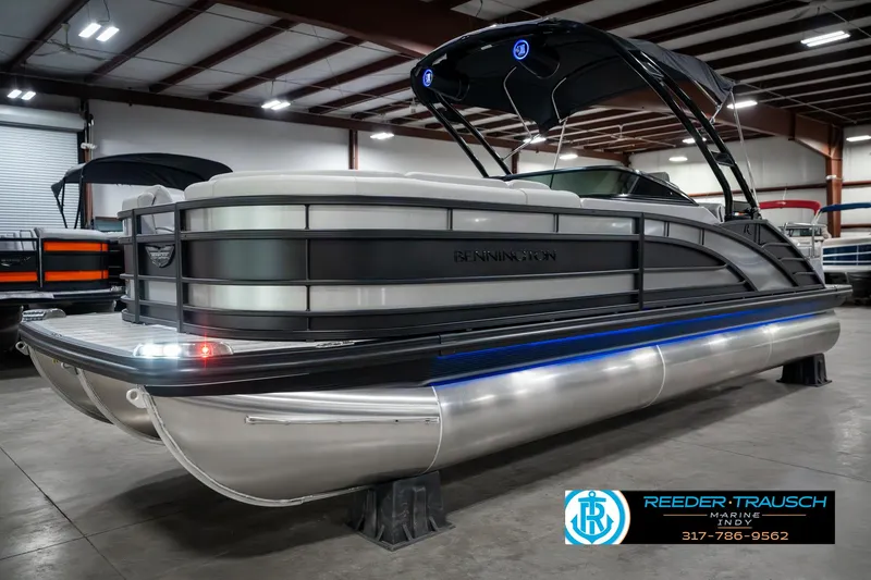 Slide: The Image of 2025 Bennington 23 RSBWA pontoon boat in showroom, featuring sleek design and modern amenities. - 3