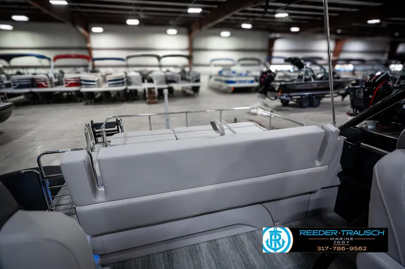 Slide: The Image of 2025 Bennington 23 RSBWA boat interior in showroom with seating and logo. - 30