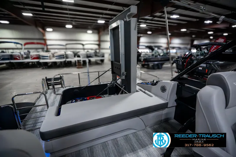 Slide: The Image of 2025 Bennington 23 RSBWA boat interior in showroom, featuring sleek seating and modern design. - 33