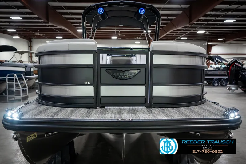 Slide: The Image of 2025 Bennington 23 RSBWA pontoon boat in showroom, rear view with logo and lights. - 4