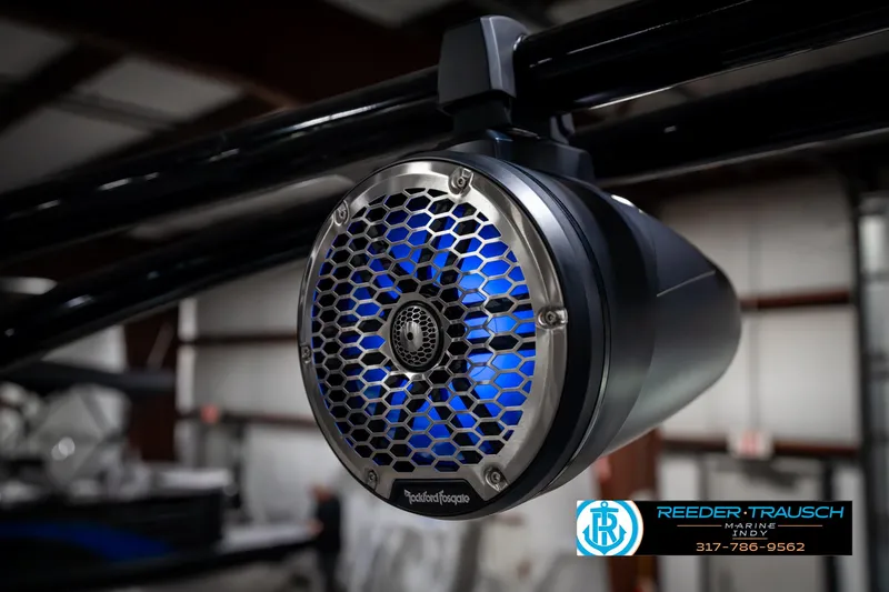 Slide: The Image of 2025 Bennington 23 RSBWA boat speaker with blue LED lighting in a showroom. - 49