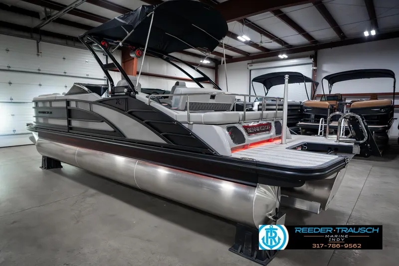 Slide: The Image of 2025 Bennington 23 RSBWA pontoon boat in showroom, sleek design, black and silver finish. - 9