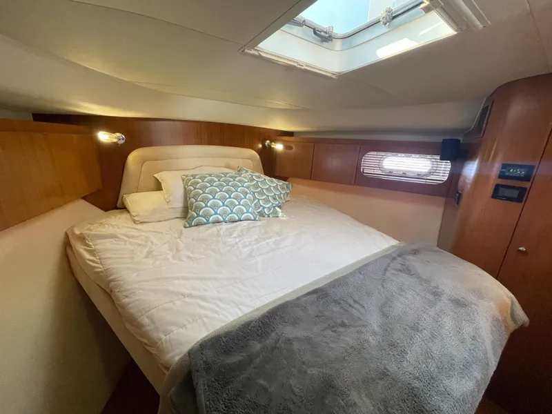 Slide: The Image of 2005 Tiara Yachts 4400 Sovran cabin with cozy bed and natural light. - 16