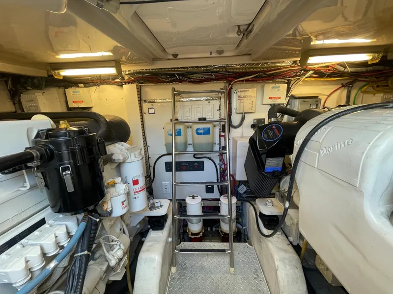Slide: The Image of Engine room of 2005 Tiara Yachts 4400 Sovran, featuring mechanical equipment and wiring. - 19