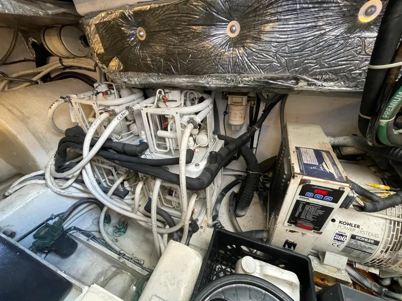 Slide: The Image of Engine room of 2005 Tiara Yachts 4400 Sovran, showcasing complex machinery and wiring. - 20