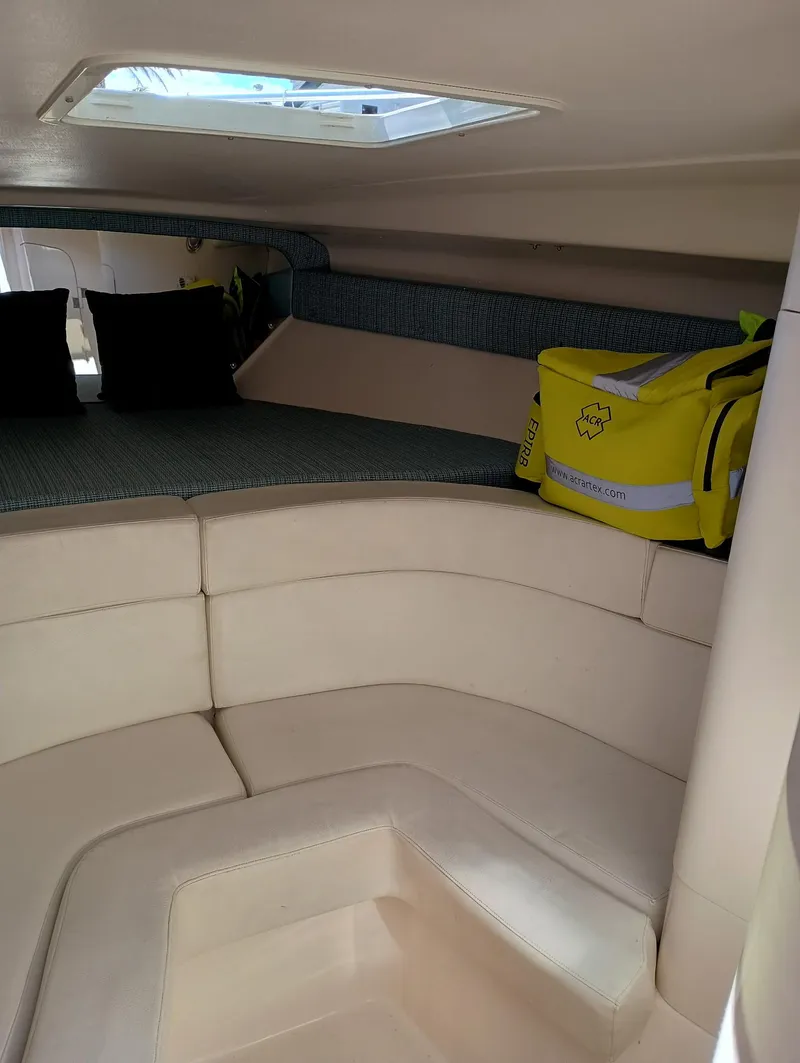Slide: The Image of 1998 Intrepid 356 Center Console Cuddy interior with seating and storage. - 14