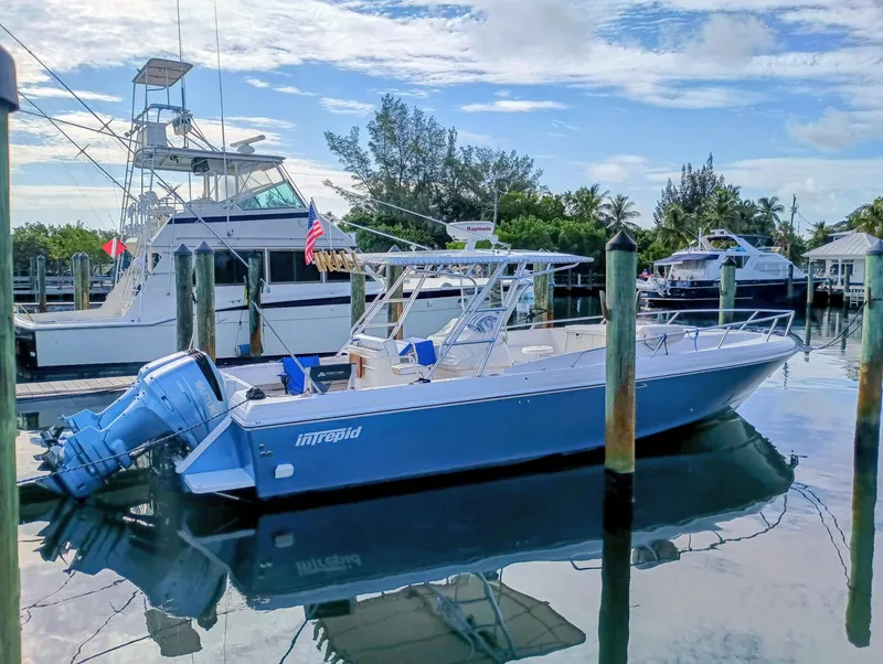 Slide: The Image of 1998 Intrepid 356 Center Console Cuddy boat docked in a marina. - 3