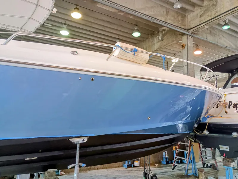 Slide: The Image of 1998 Intrepid 356 Center Console Cuddy boat in a maintenance facility. - 7