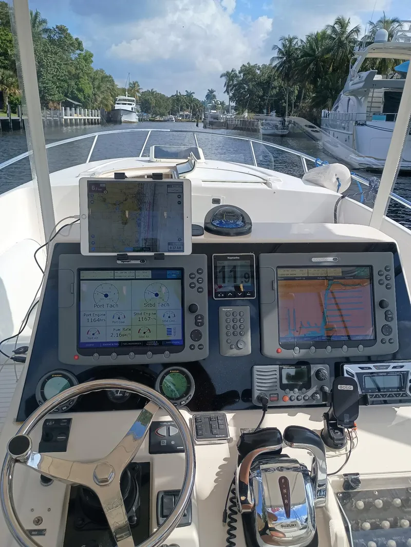 Slide: The Image of 1998 Intrepid 356 Center Console Cuddy helm with navigation screens, steering wheel, and controls. - 8