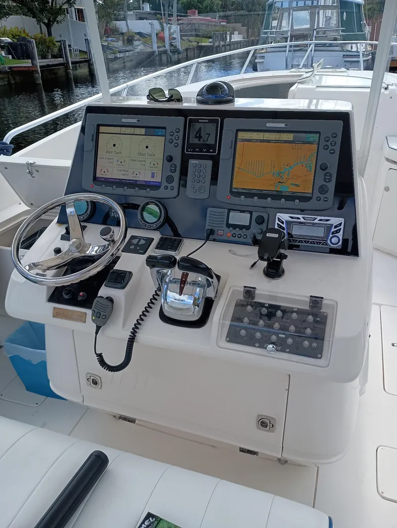 Slide: The Image of 1998 Intrepid 356 Center Console Cuddy helm with navigation displays and controls. - 9