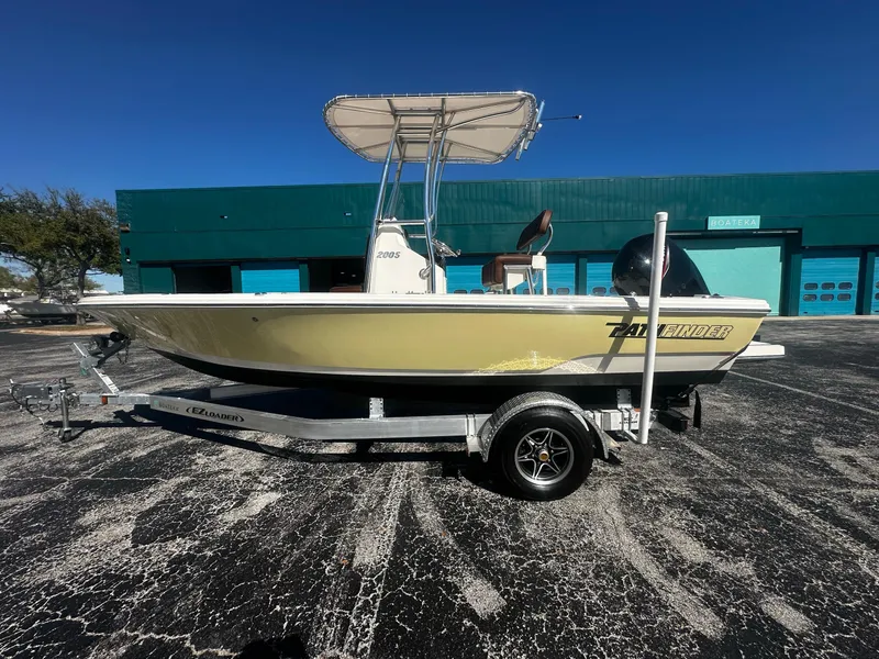 The Image of Pathfinder 2005 TRS boat on trailer, parked outdoors, sunny day, 2022 model. - 1