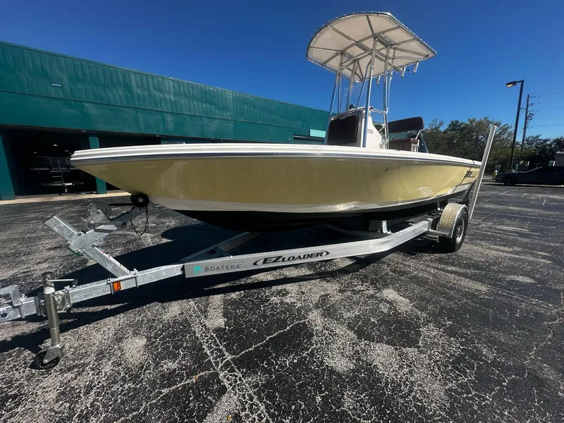 Slide: The Image of Yellow 2005 Pathfinder TRS boat on trailer, parked outdoors, sunny day. - 3