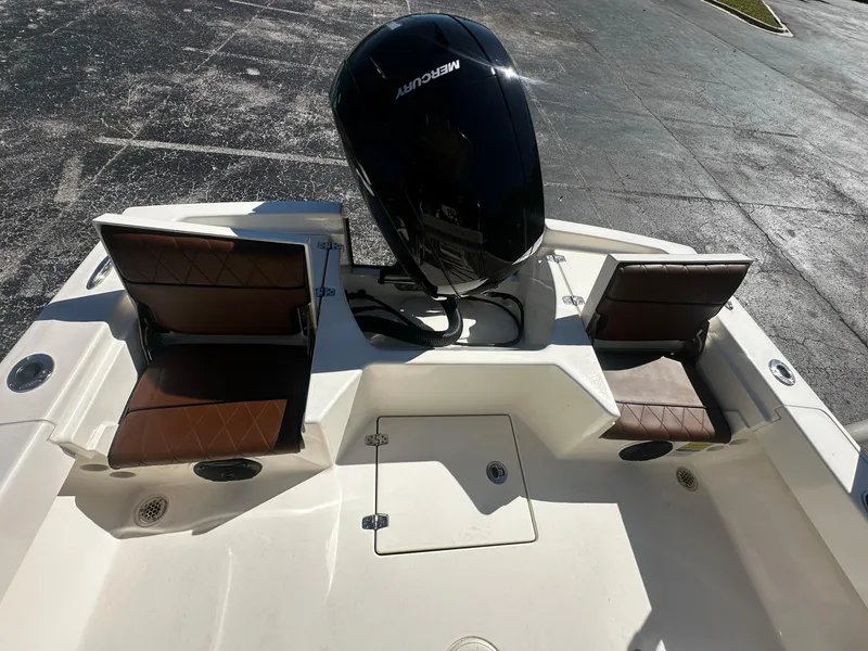 Slide: The Image of Pathfinder 2005 TRS boat with Mercury engine, featuring brown seats and storage compartments. - 5