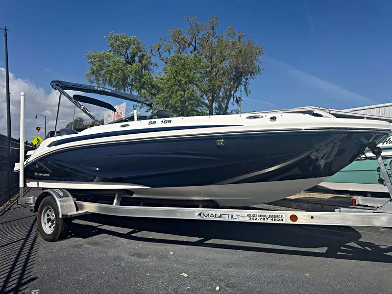 The Image of 2024 Hurricane SunDeck Sport 185 OB boat on trailer, parked outdoors. - 0