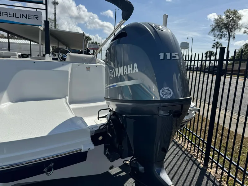 Slide: The Image of 2024 Hurricane SunDeck Sport 185 OB with Yamaha 115 outboard motor, docked outdoors. - 14