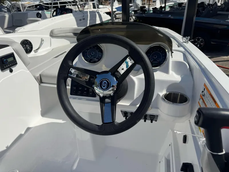 Slide: The Image of 2024 Hurricane SunDeck Sport 185 OB steering console with gauges and controls. - 2