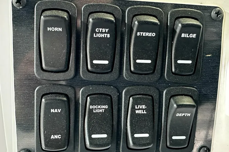 Slide: The Image of Control panel of 2025 Hurricane SunDeck Sport 185 OB boat with labeled switches. - 9