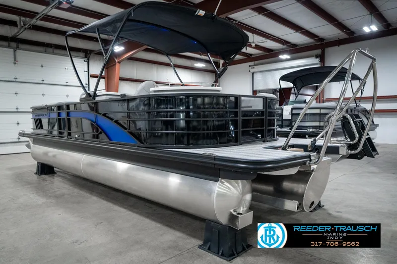 Slide: The Image of 2025 Bennington 25 LPD pontoon boat in showroom, featuring sleek design and modern amenities. - 10