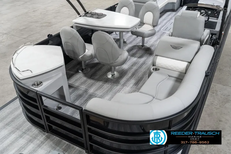 Slide: The Image of 2025 Bennington 25 LPD pontoon boat interior with plush seating and table. - 14