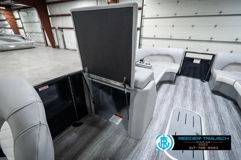 Slide: The Image of 2025 Bennington 25 LPD interior with seating and storage in a showroom. - 25