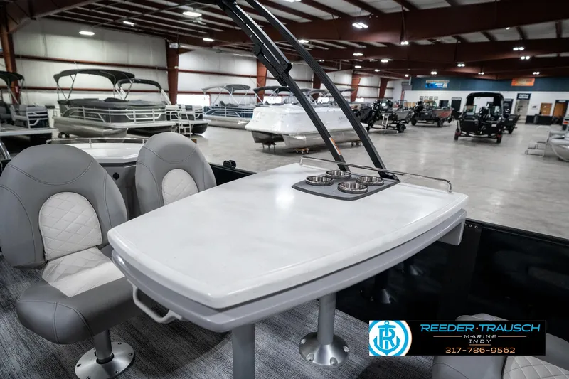 Slide: The Image of 2025 Bennington 25 LPD boat interior with seating and table in showroom. - 26