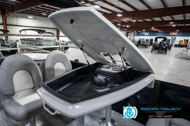 Slide: The Image of 2025 Bennington 25 LPD boat interior with open storage compartment and seating. - 27