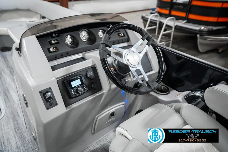 Slide: The Image of 2025 Bennington 25 LPD boat dashboard with steering wheel and control panel. - 35