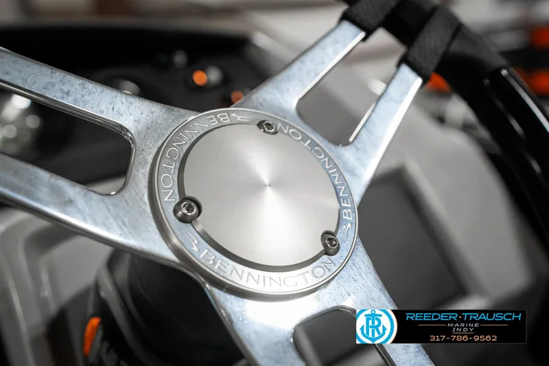 Slide: The Image of Steering wheel of 2025 Bennington 25 LPD boat, featuring sleek metallic design. - 36
