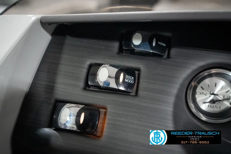 Slide: The Image of Control panel of 2025 Bennington 25 LPD boat with switches and clock. - 39