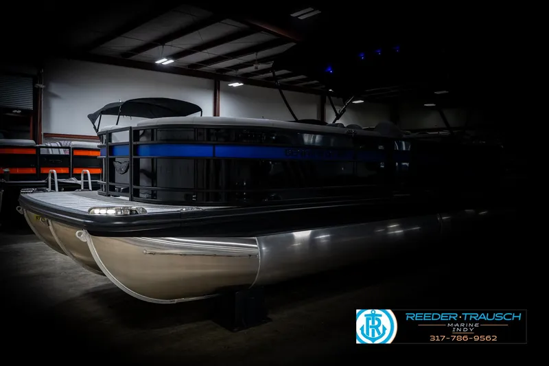 Slide: The Image of 2025 Bennington 25 LPD pontoon boat in a dimly lit indoor setting. - 4